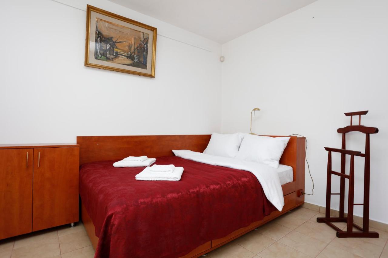 The bedroom, with a wooden wardrobe and clothes valet
