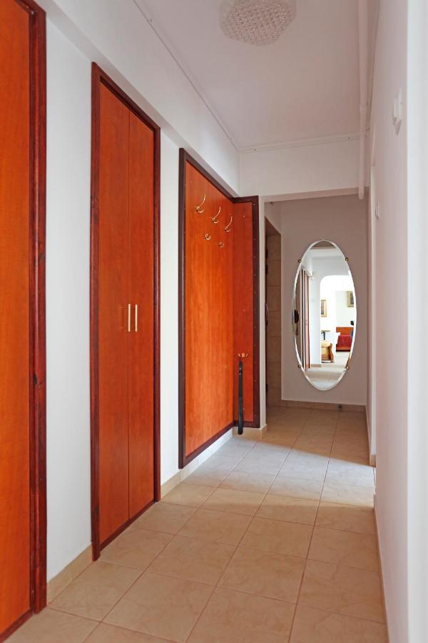 The hallway, with wooden doors and an oval mirror