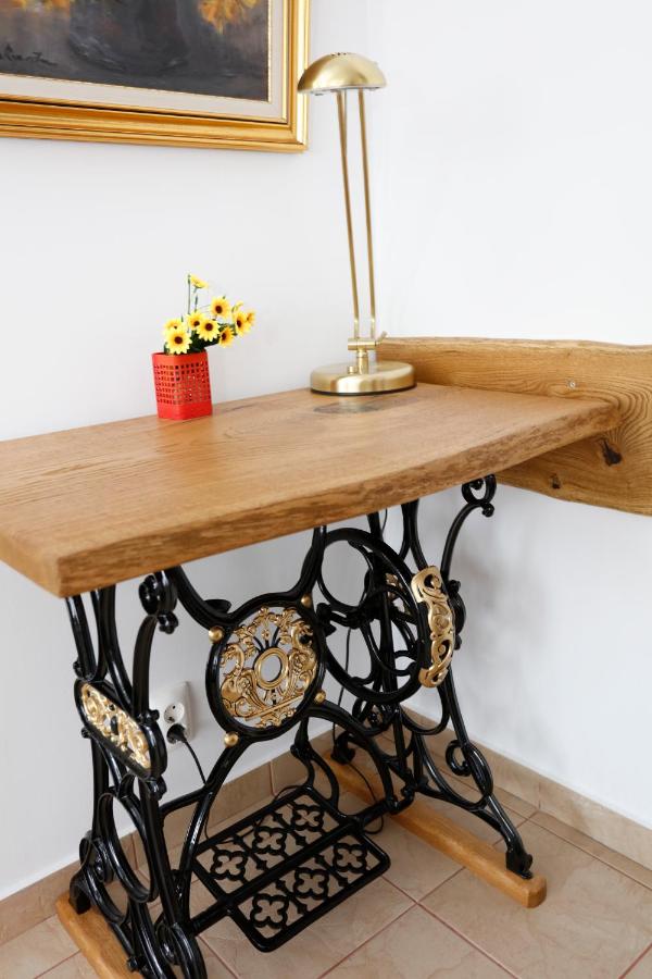 A brass lamp and yellow flowers on the desk
